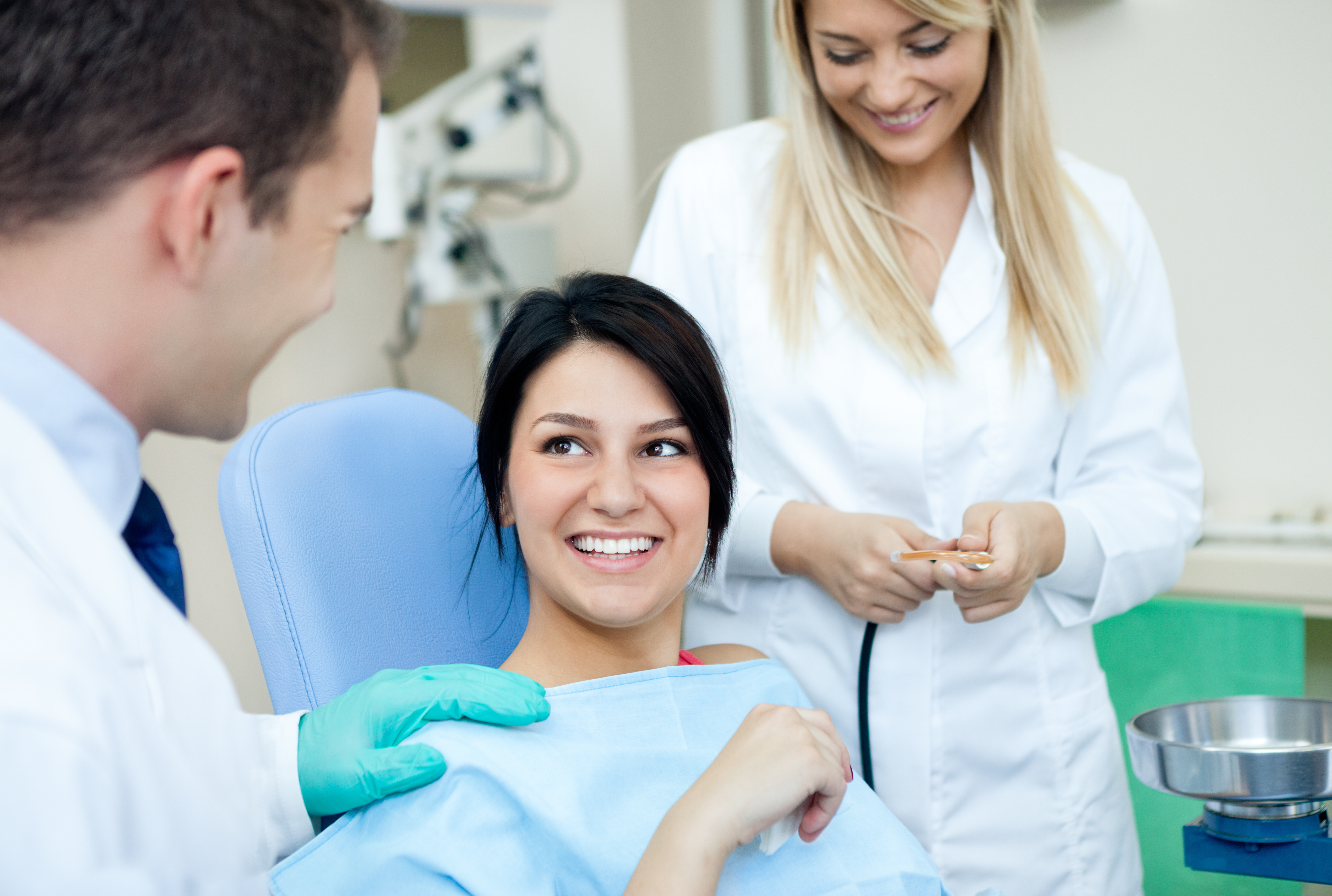 patient smiling with dentists